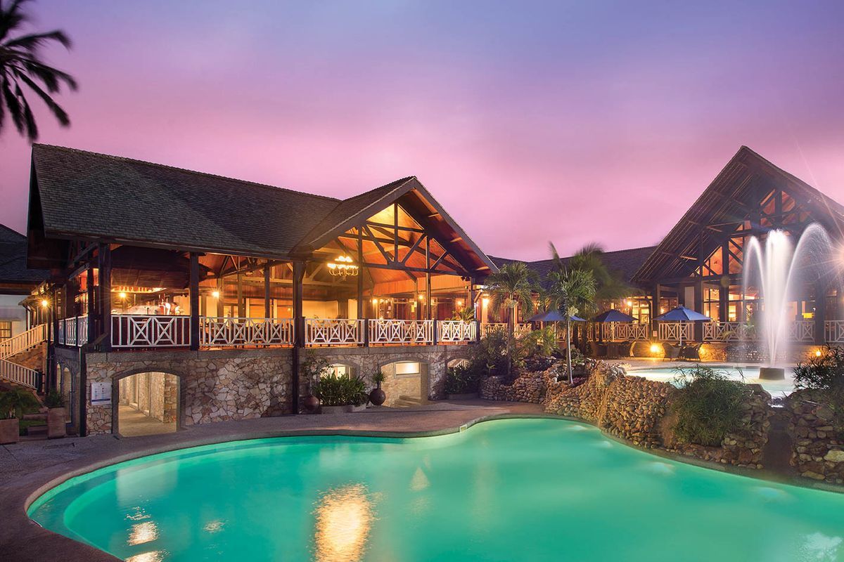 Luxury safari lodge with pool at sunset in Ghana